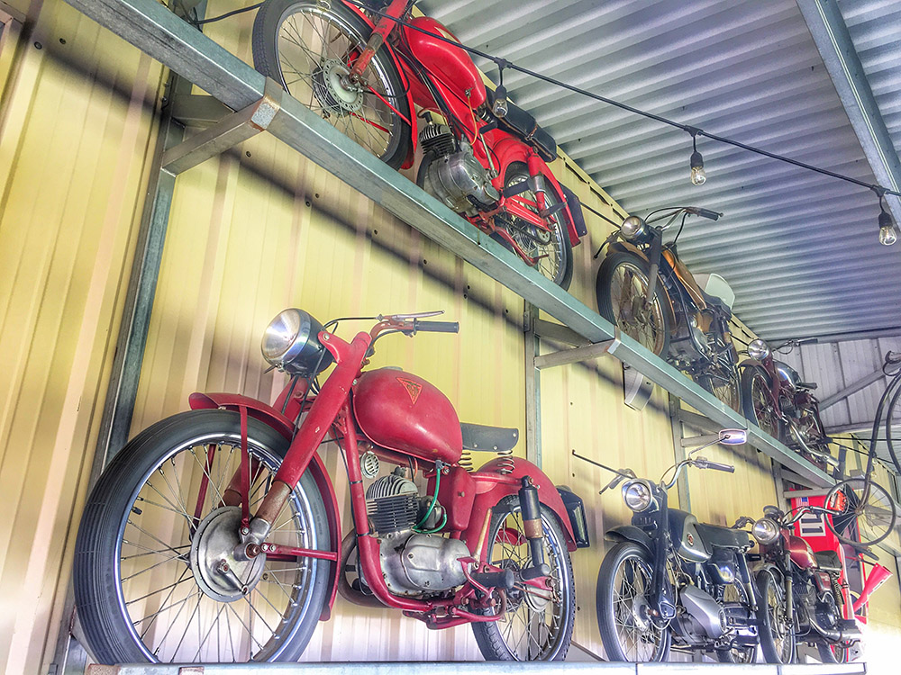 vintage motorcycles hanging on a display wall